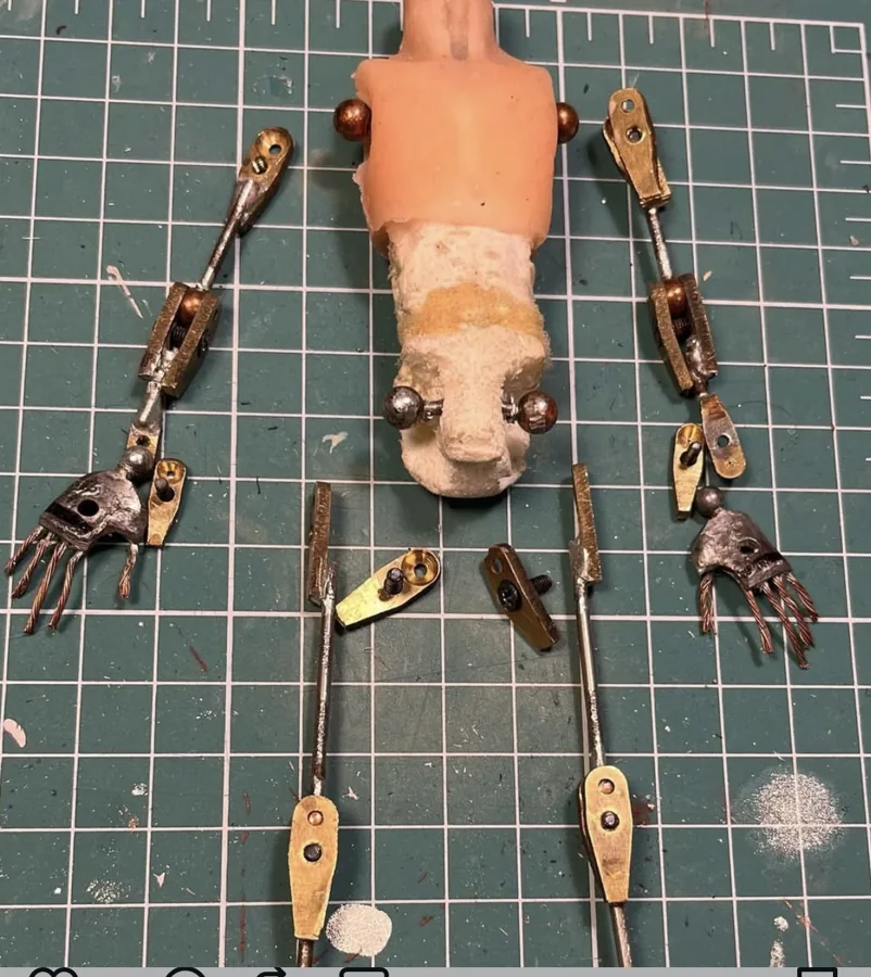 Puppet armature laid out on a cutting mat