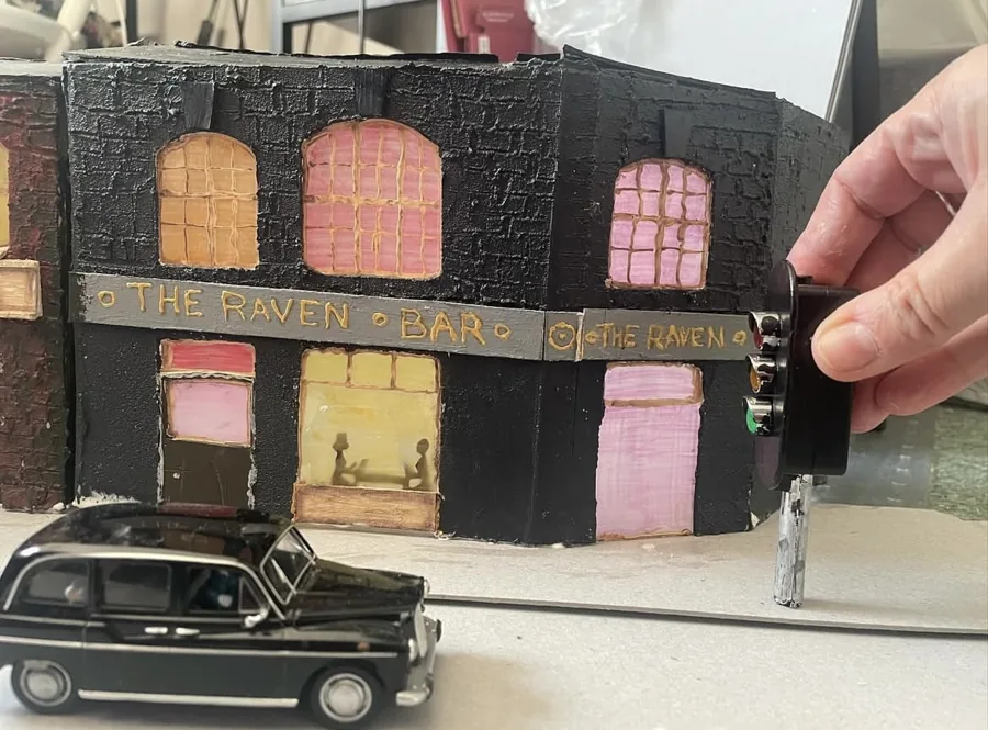 A miniature car beside the street set