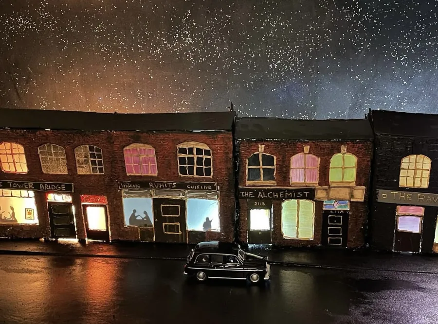 The miniature street illuminated at night