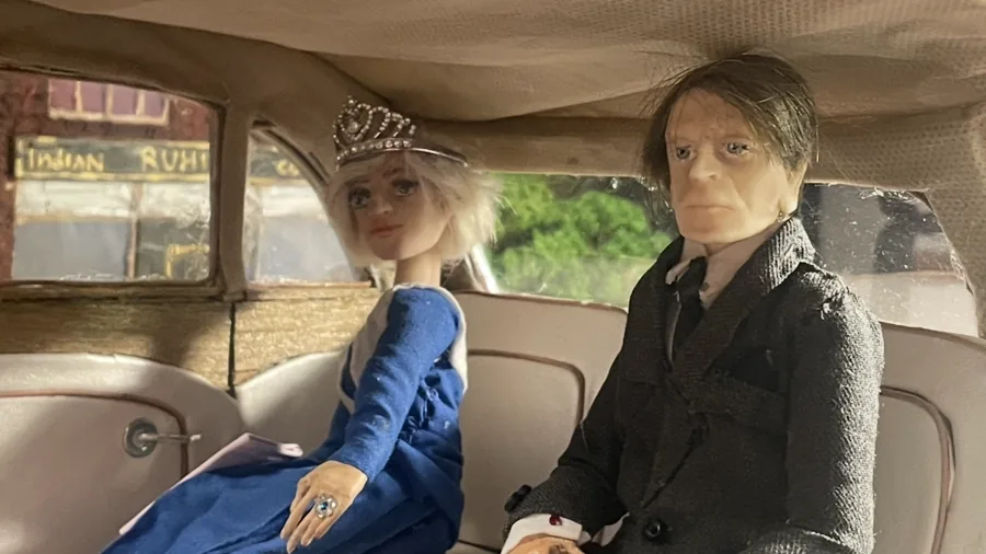 Puppet character at the wheel