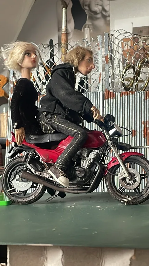 Puppets on a miniature motorcycle