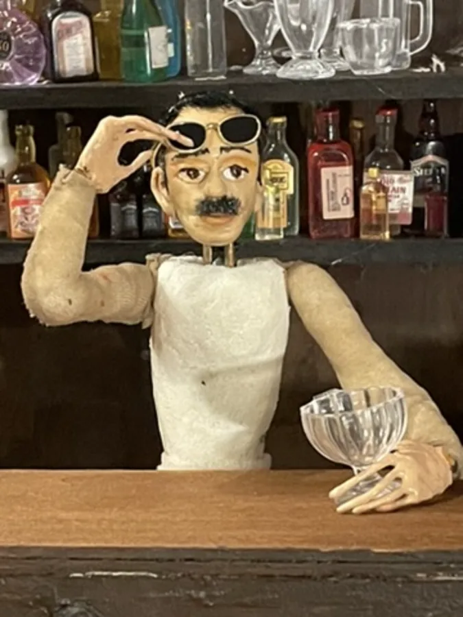 A puppet leaning over a counter