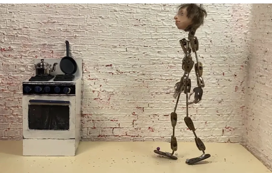 Puppet armature beside a miniature kitchen