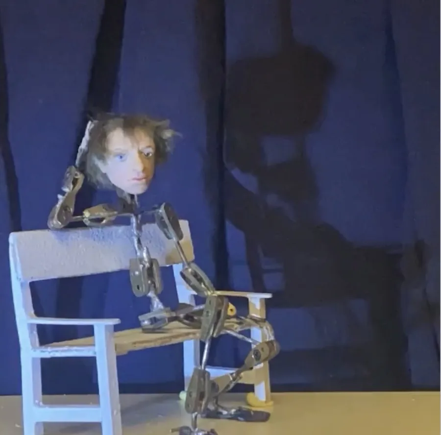 Puppet under blue stage lighting