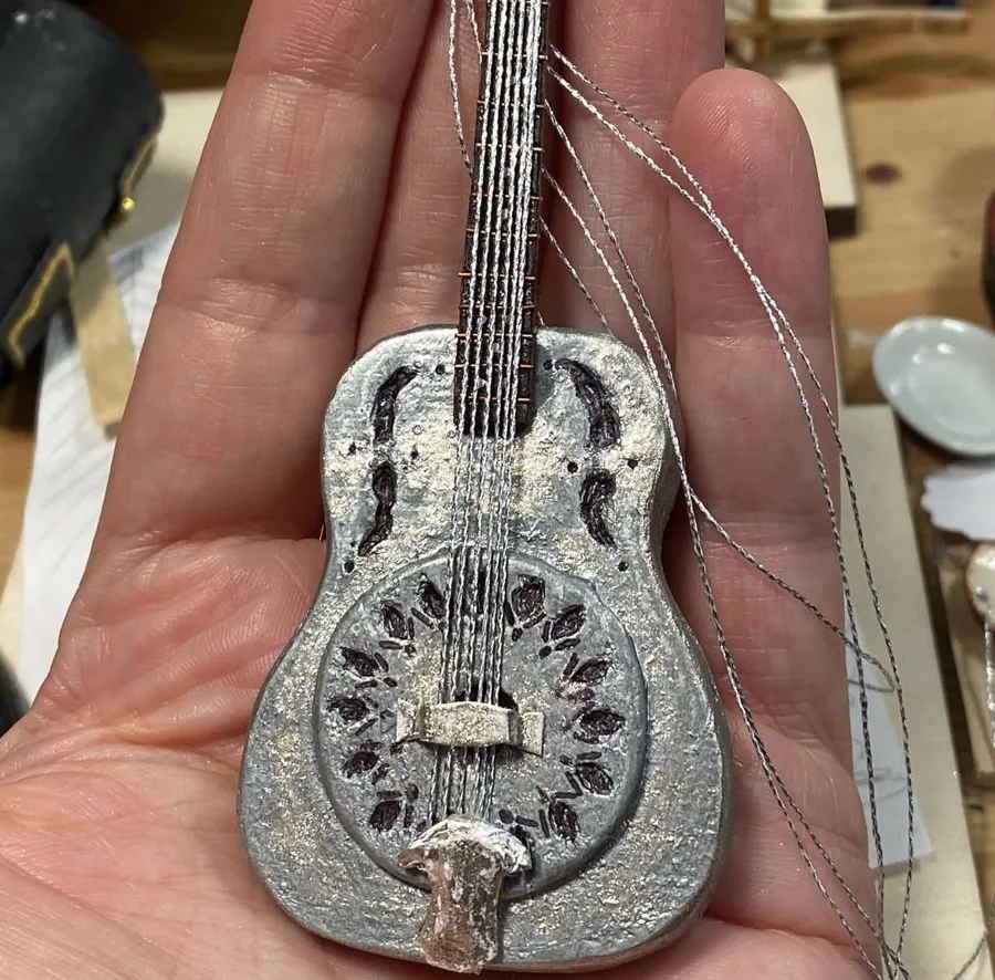 Intricate miniature instrument held in a hand